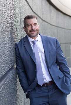 Profile shot of Rob Quin in navy suit